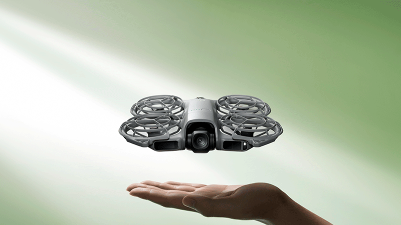 Дрон DJI Neo 2 зависает над раскрытой ладонью, демонстрируя функцию взлёта и посадки с руки